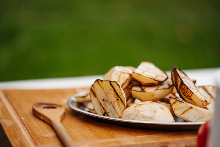 Grilled apple slices with char marks on serving plate.