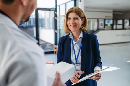 Female medical sales representative presenting medication to doctorの写真素材