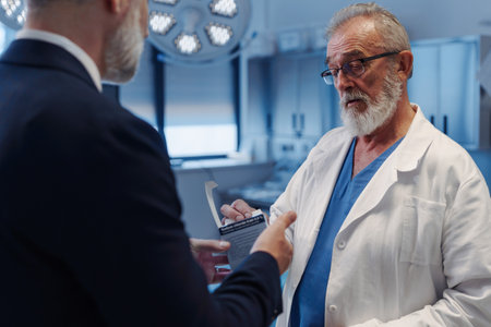 Medical sales representative introducing pharmaceutical products to doctor. Hospital setting.の写真素材