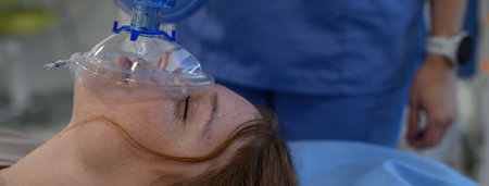 Medical staff applying oxygen mask to unconscious teenage girl in hospital.