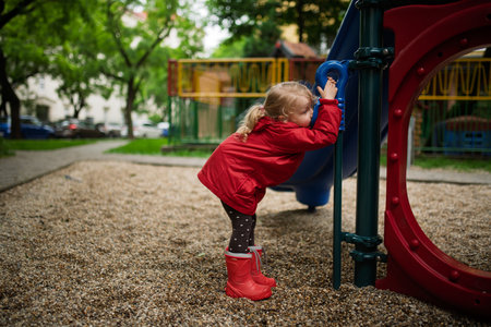 Little girl playing on outdoor playgroundの写真素材