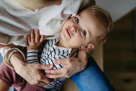 Beautiful mother hugging little son,の写真素材
