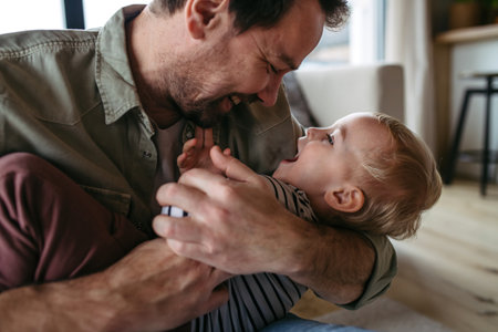Mature father playing with little son,の写真素材