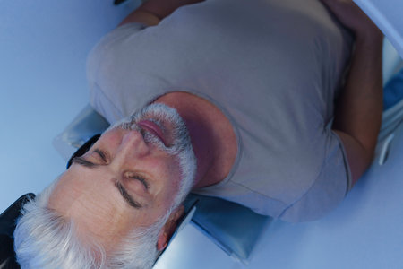 Male patient undergoing CT scan examination in hospital.