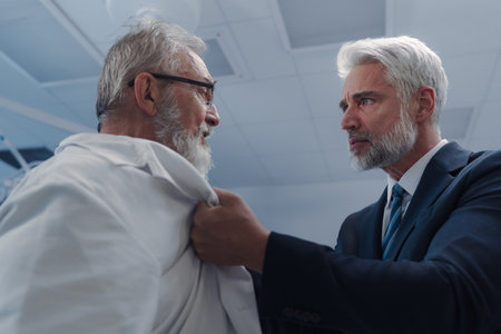 Man have conflict with doctor, holding him by coat.の写真素材