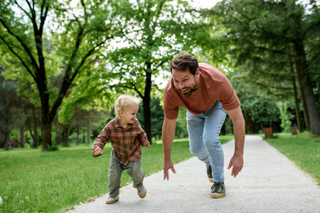 Father lining up to have a running race with his little son.の写真素材