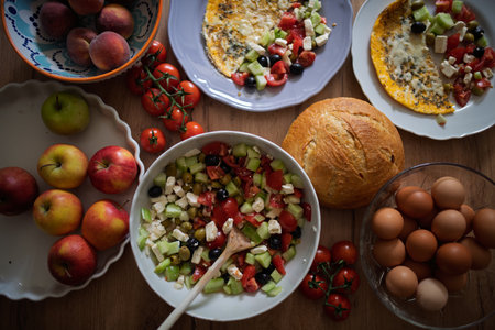 Omelet with Greek salad and fresh breadの写真素材