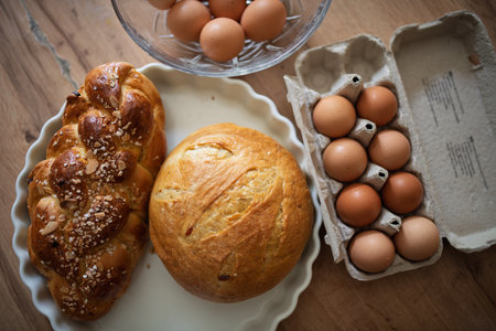 Homemade bread and eggs on rustic kitchen tableの写真素材
