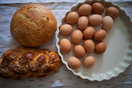 Homemade bread and eggs on rustic kitchen tableの写真素材