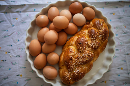 Homemade braided bread and eggs on rustic kitchen tableの写真素材