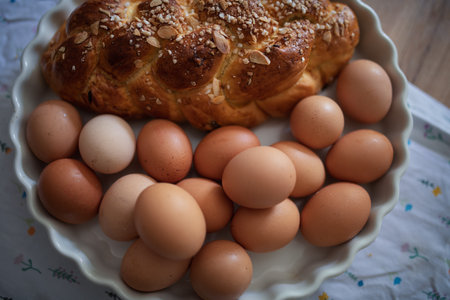 Homemade braided bread and eggs on rustic kitchen tableの写真素材