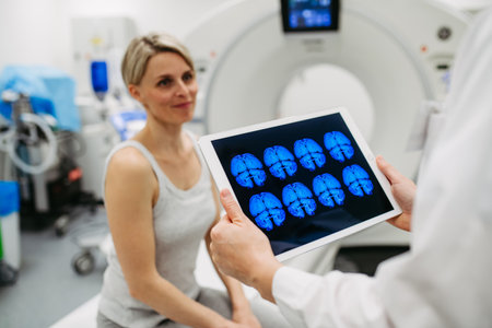 Doctor explaining CT scan results to female patient in imaging roomの写真素材