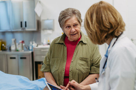 Geriatrician talking about test results with senior patient during check-up.の写真素材