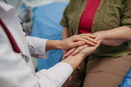 Caring doctor holding senior patient hand.の写真素材