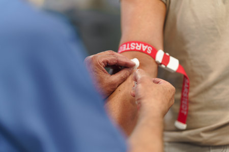 Doctor taking patients blood pressure using digital blood pressure monitor.の写真素材