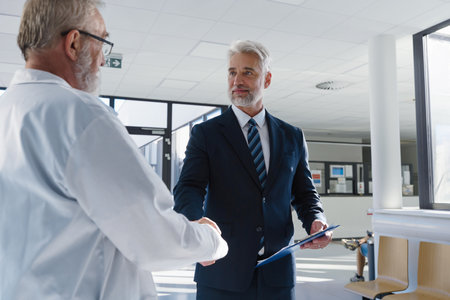 Portrait of manager shaking hand with doctor.の写真素材
