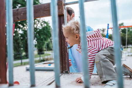 Portrait of dad and child enjoying time together on the playground.の写真素材