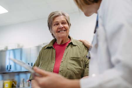 Geriatrician talking about test results with senior patient during check-up.の写真素材