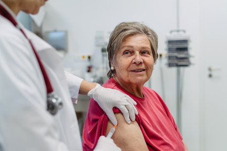 Elderly patient being vaccinated by doctor.の写真素材