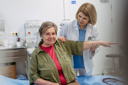 Geriatrician examining senior womans mobility during routine check-up,の写真素材