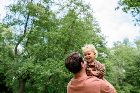 Portrait of dad hugging little son, enjoying time togetherの写真素材