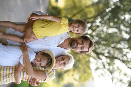 A portrait of young family with small children in sunny summer nature.の写真素材