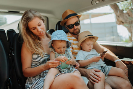 Family road trip with kids in backseat of vehicleの写真素材