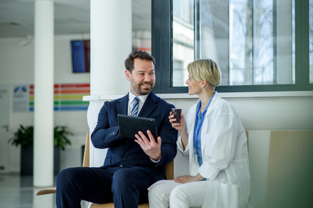 Pharmaceutical sales representative introducing new medication to female doctor.の写真素材