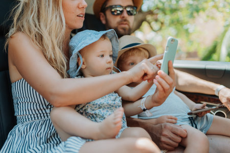 Family road trip with kids in backseat of vehicleの写真素材
