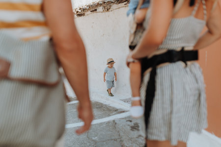 Family with two toddler children walking in town on summer holiday.の写真素材