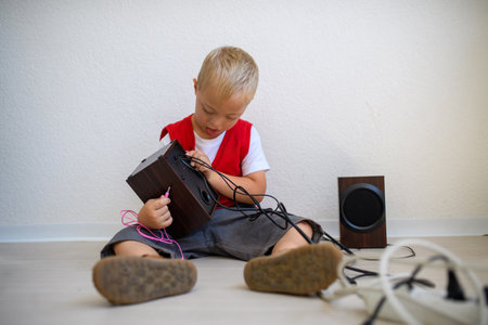 School boy during hands-on learning, connecting audio outputs.