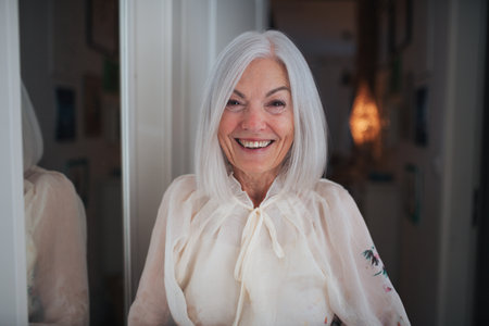 Portrait of beautiful senior woman, looking at camera and smiling.