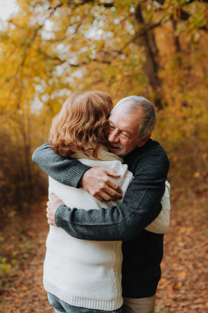 Older couple spending time outdoors in fall season.の写真素材