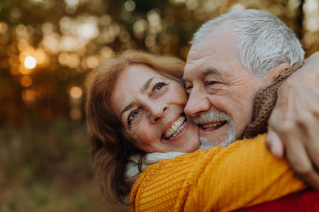 Senior couple enjoying autumn walk in nature,