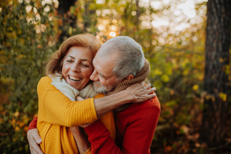 Portrait of senior couple in autumn nature.の写真素材