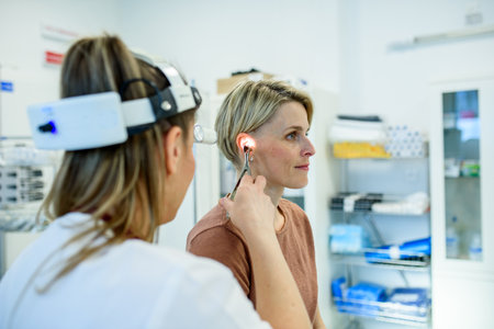 Female patient undergoing ear check-up at specialist appointmentの写真素材
