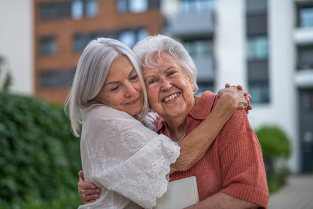 Portrait of beautiful adult daughter with old mother.の写真素材