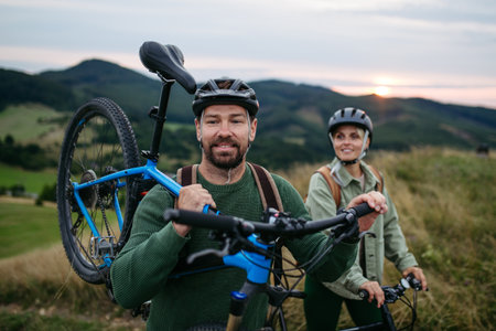 Couple cycling together in nature, smiling and enjoying outdoor adventure.の写真素材