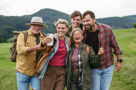 Family taking selfie on hiking trip in the nature.