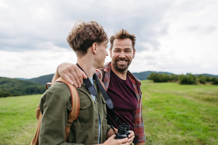 Father spending weekend with son on hike in nature.