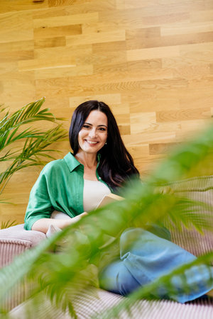 Portrait of smiling woman enjoying a peaceful moment at home