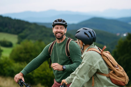 Couple cycling together in nature, smiling and enjoying outdoor adventure.