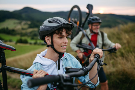 Older couple cycling together in nature, smiling and enjoying outdoor adventure.