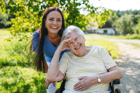 Home nurse taking care of elderly woman in wheelchair.