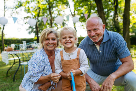 Smiling senior couple with grandchild at family gathering.