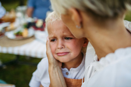 Mom trying to calm down crying toddler boy.の写真素材