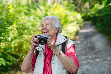 Elderly woman photographing nature during forest walk.