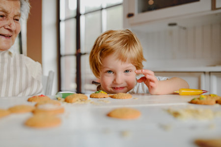 Christmas baking tradition with grandma and little kid.の写真素材
