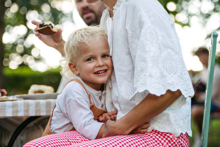 Toddler hugging his mom during family garden party.の写真素材