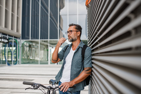 Mature man brushing teeth outdoors.の写真素材